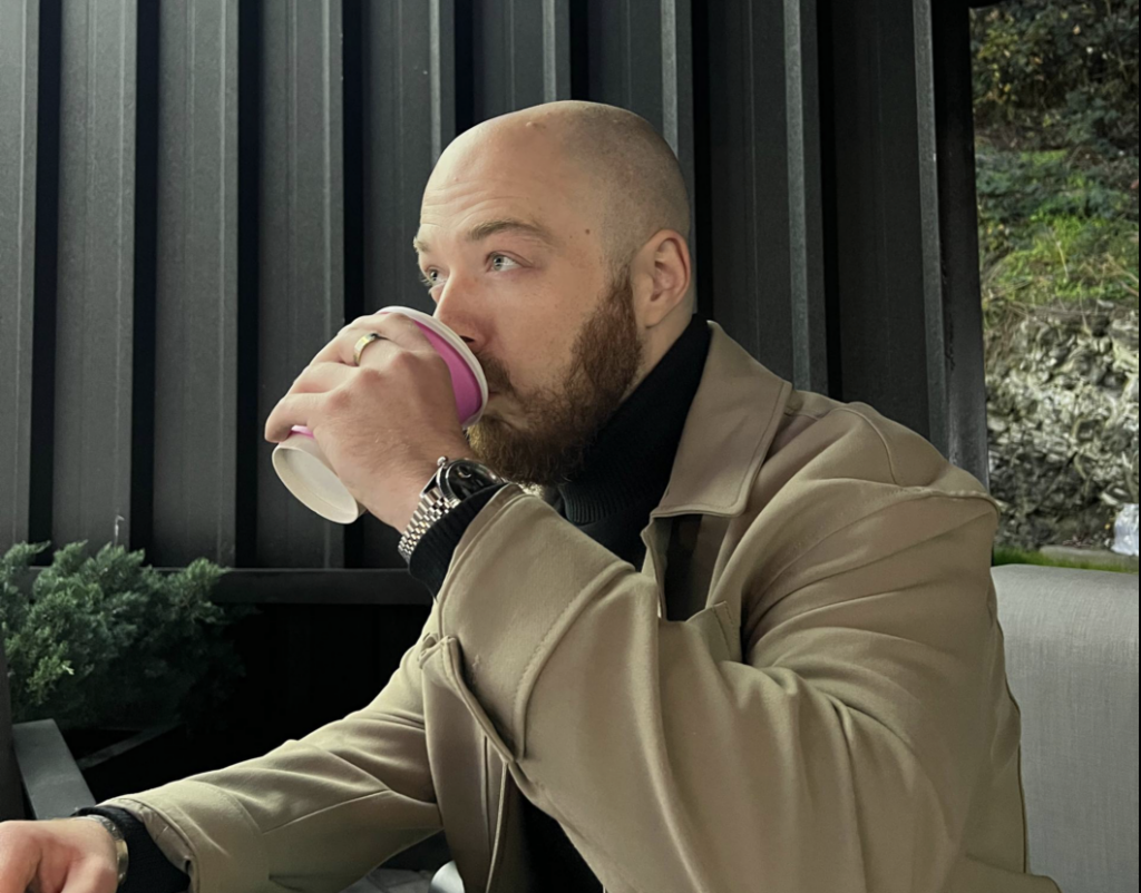 Dylan Madden drinking coffee while living abroad