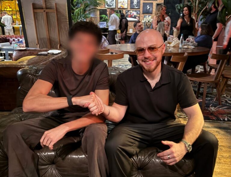 Dylan Madden shaking hands with a business owner he mentors